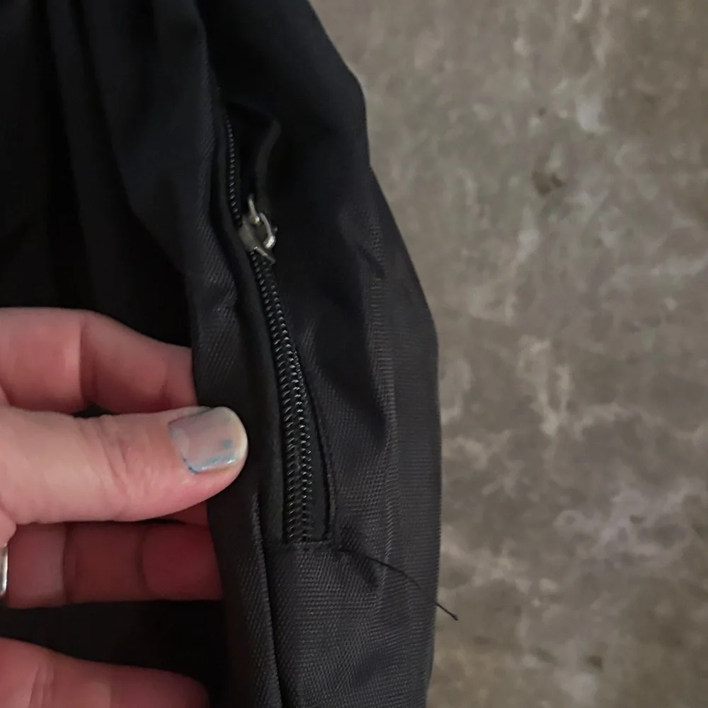 Black Backpack with Green Logo